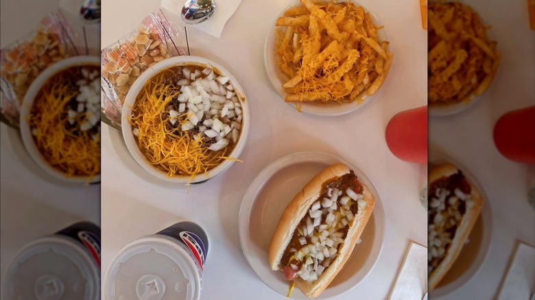 A bowl of Michigan chili, a plate of chili cheese fries, and a Coney dog