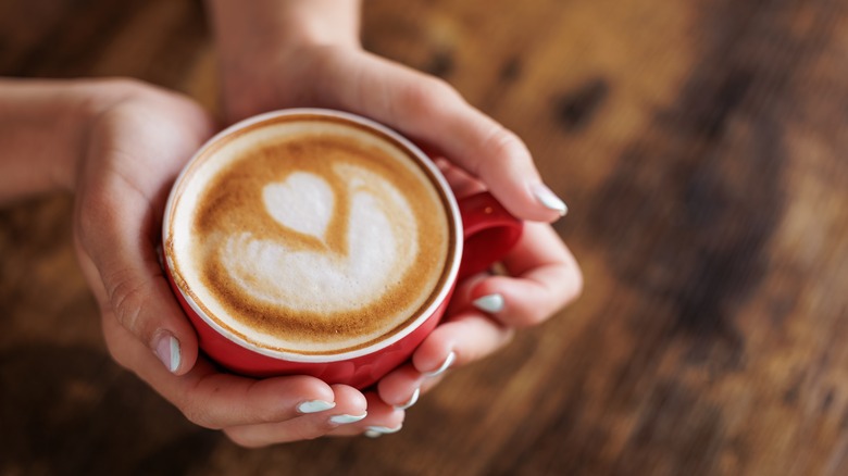 Hands holding a cup of coffee
