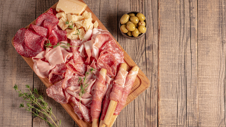 A charcuterie board with a variety of meats