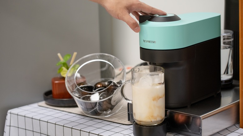 A person using a Nespresso machine