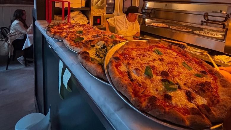 Several pizza varieties on the pass at Jules.