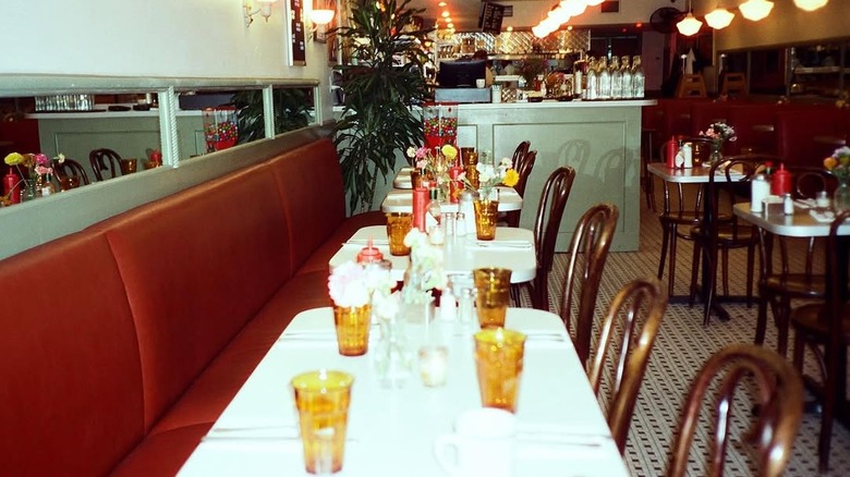 A banquette with tables and chairs in the dining room at Montague diner.