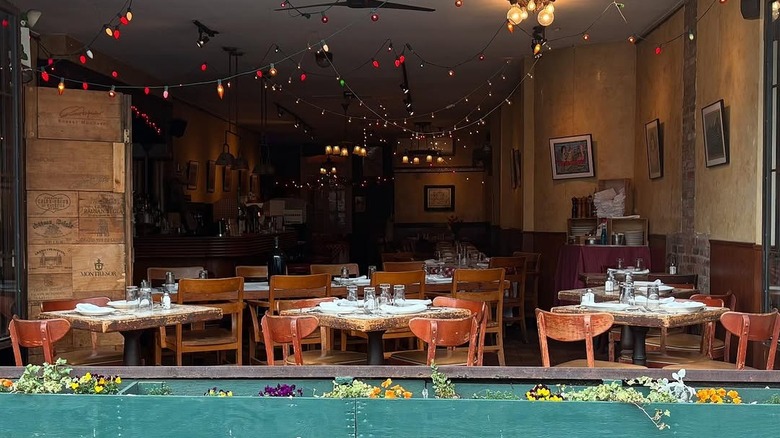 The dining room at Noodle Pudding seen through a big window.