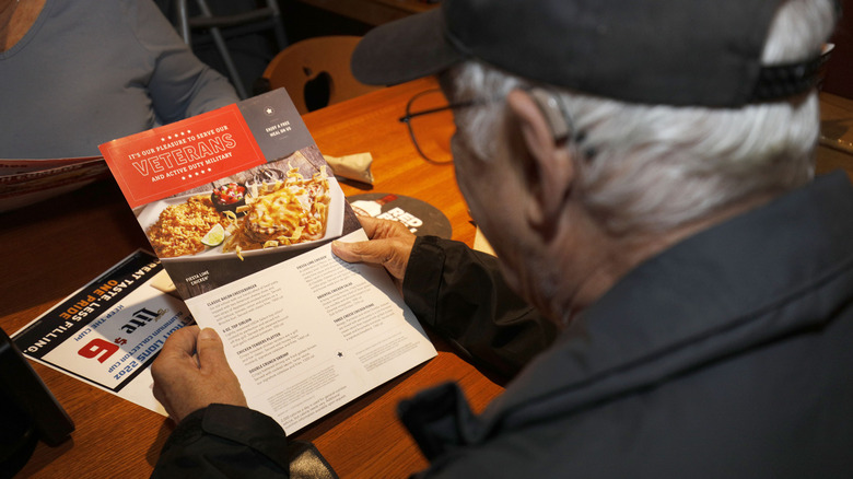 A man looks at the Applebee's Veterans Day menu