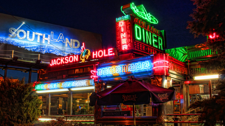 Exterior of the Jackson Hole Diner, with its neon signs lit up at night