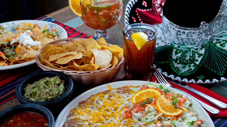 Table wtih Mexican food on woven placemats with sombrero