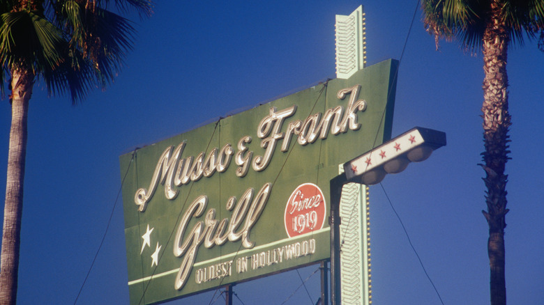 Musso & Frank's tall sign, between two palm trees