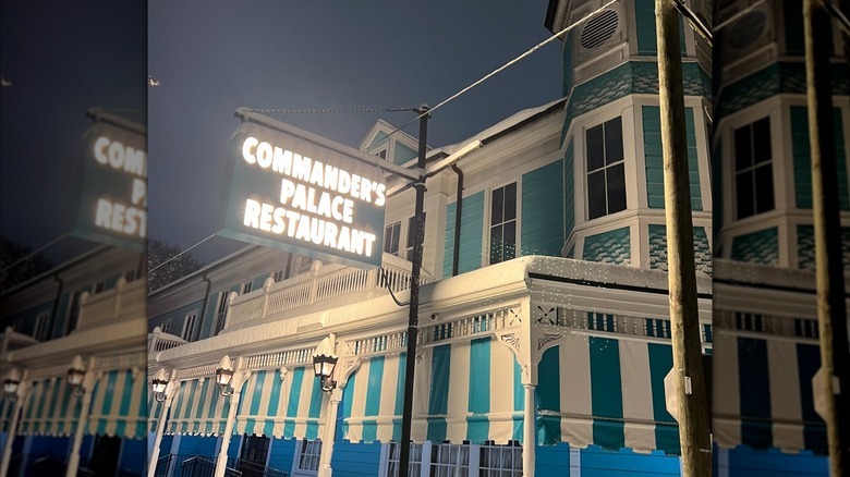 The outside of the restaurant with an illuminated sign