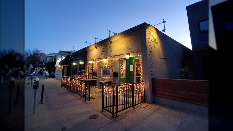The restaurant exterior with hanging lights on the railing