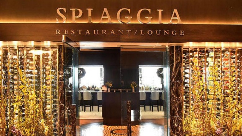 The front entrace of Spiaggia with glass doors and gold lights