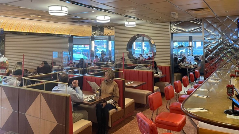 Booths and a long counter with red vinyl chairs