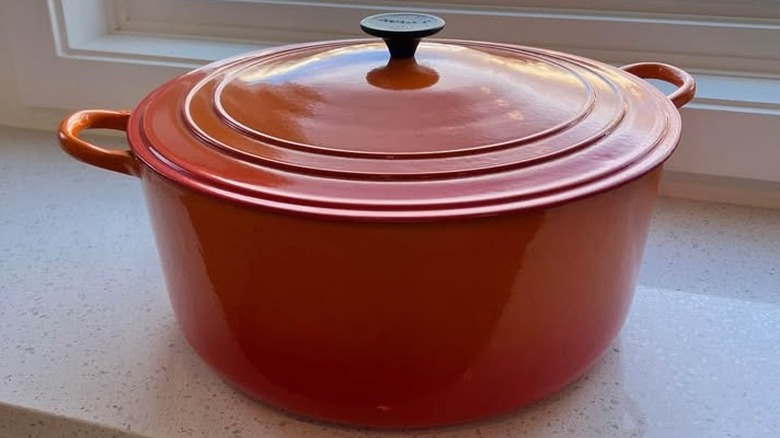 An orange/volcanic Size K Dutch oven from Le Creuset.