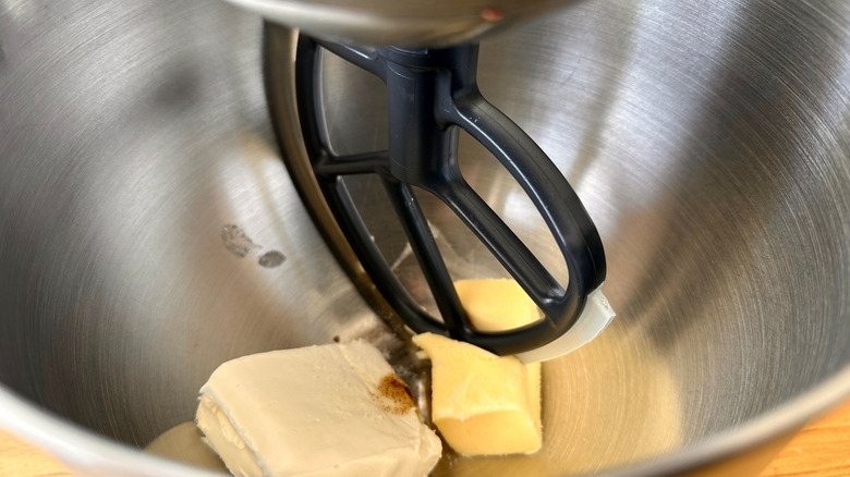 Butter, cream cheese, and paddle attachment in mixing bowl