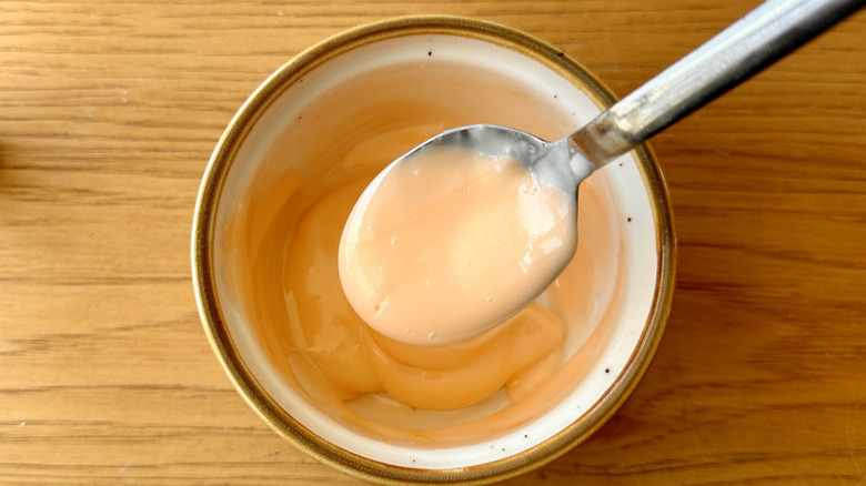 Orange-hued icing in ramekin