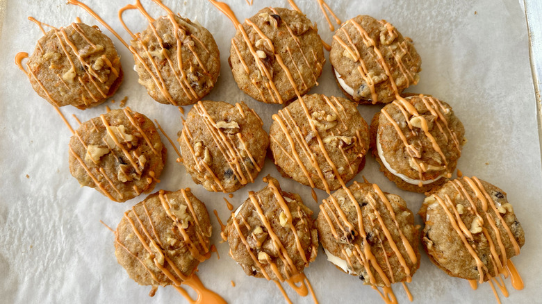 Carrot cake cookie sandwiches drizzled with icing