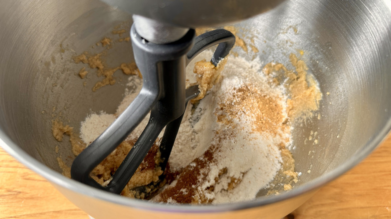 Dry ingredients in cookie dough in mixing bowl