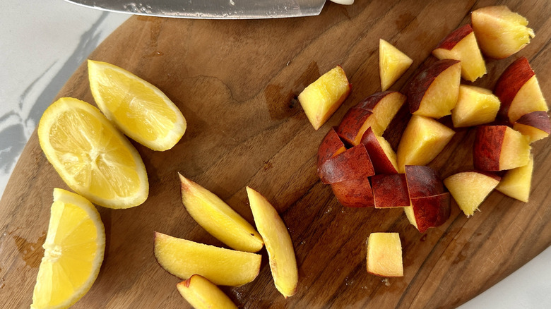 Peaches and lemons on cutting board