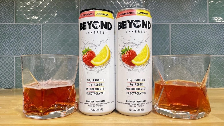 Cans and glasses of Beyond Immerse Strawberry Lemonade