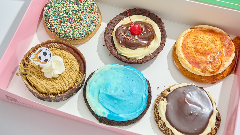 Crumbl Cookies in a world cup-themed box on a table