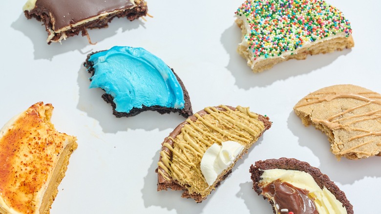 Cookies with bites taken out of them spread across a table