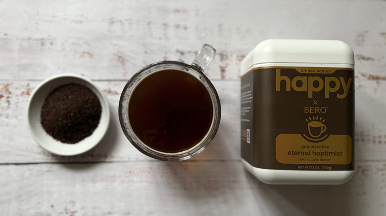 Happy coffee ground, coffee and canister in a row