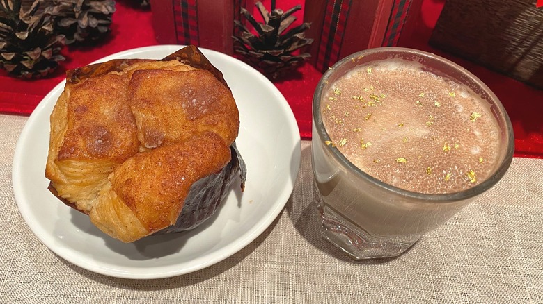 Cinnamon roll and hot chocolate beverage