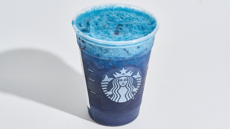 blue coconut lemonade energy refresher in a starbucks cup on a table
