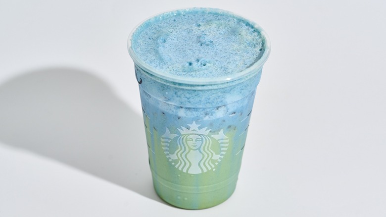 iced blue coconut matcha in a starbucks cup on a table