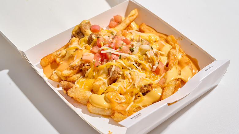 nacho fries in a pizza box on a table