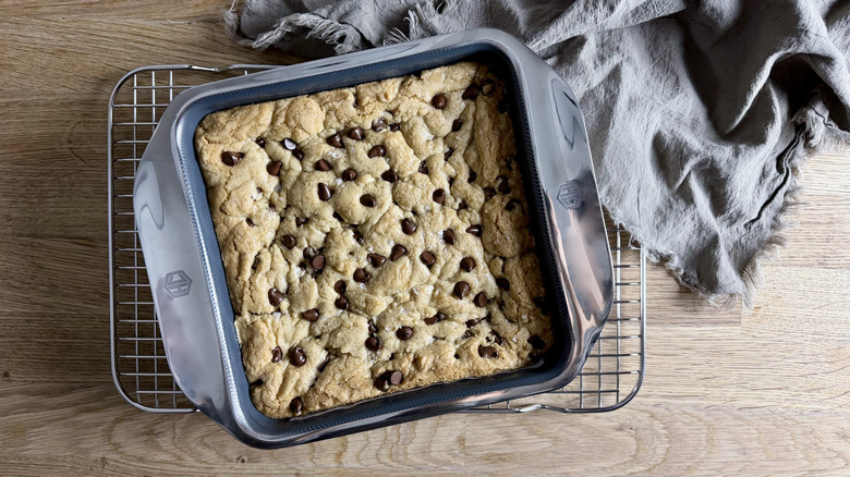 Chocolate chip blondies in a square pan on a cookie sheet