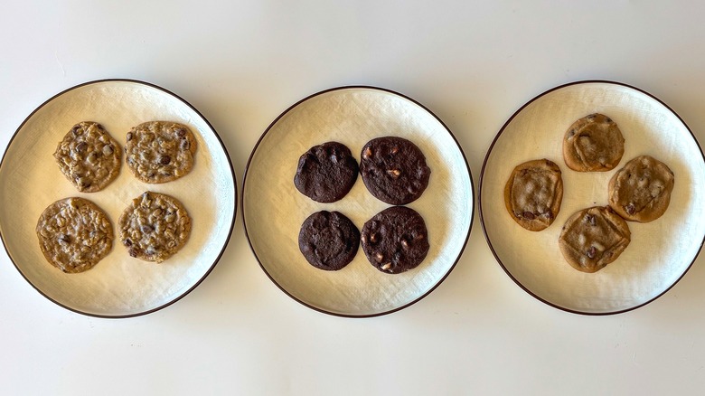 Plates of cookies on white background