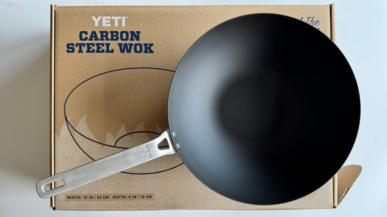 Yeti carbon steel wok on white background with packaging