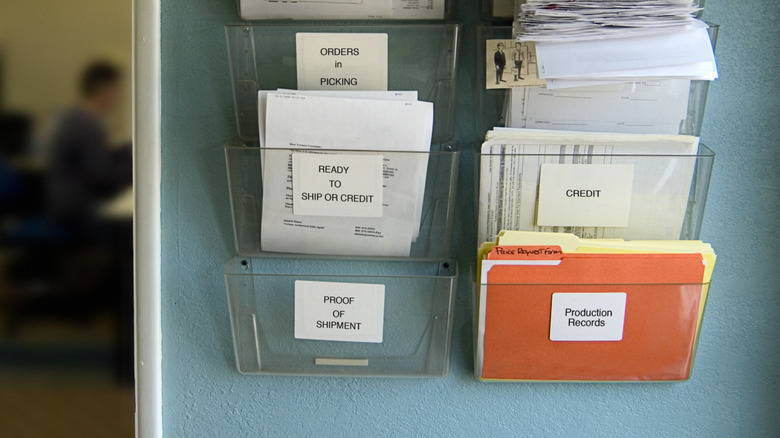 Plastic wall-mounted file holders outside of an office