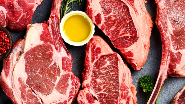 Raw tomahawk and ribeye steaks