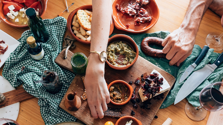 A group of people sitting around a table sharing some tapas