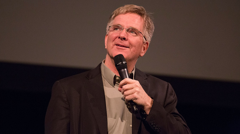 A closeup of Rick Steves speaking into a microphone
