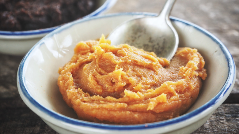 Miso paste on wood background