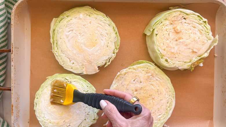 hand brushing the cabbage steaks with pastry brush