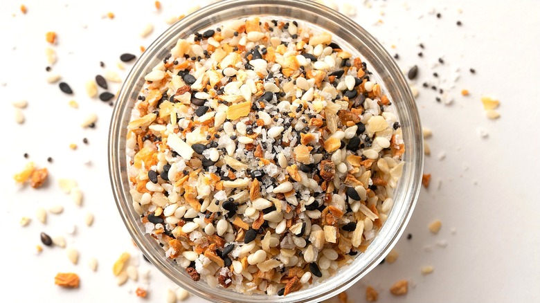 Top-down view of everything bagel seasoning in a glass jar.