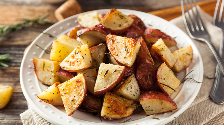 roasted herby potatoes in a white bowl