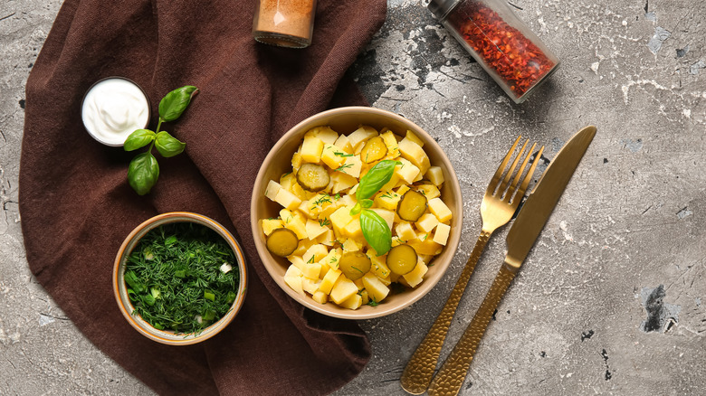 roasted potatoes in a bowl along with seasoning