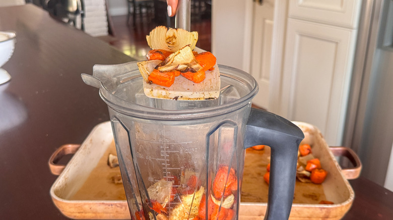 adding vegetables to blender