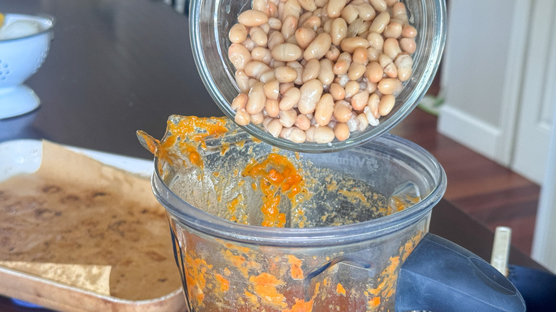 adding beans to pot