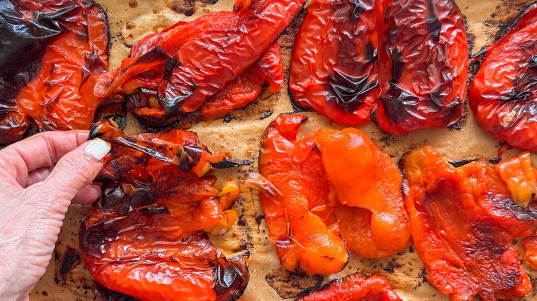hand peeling skin off pepper