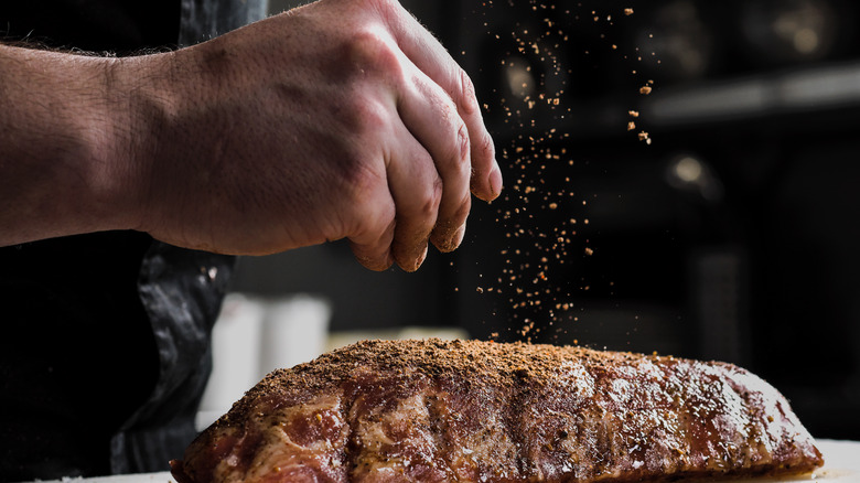 Person seasoning steak