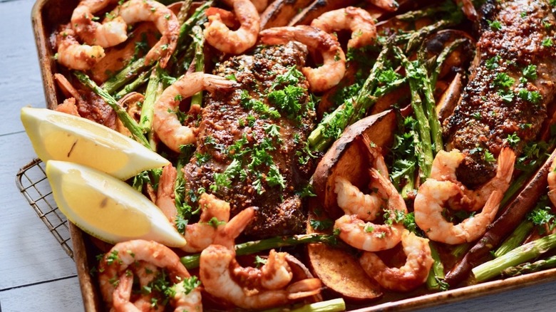 Steak and shrimp on a sheet pan.