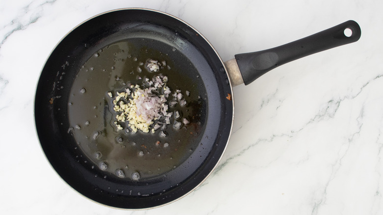 minced garlic and shallots in hot oil in a skillet