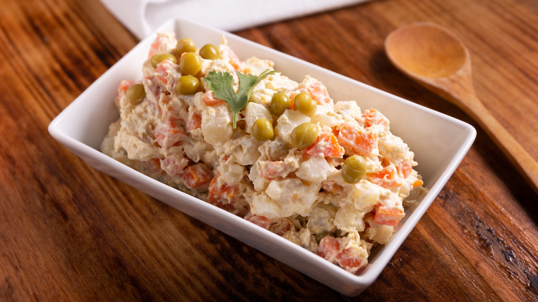 Square bowl of Russian potato salad