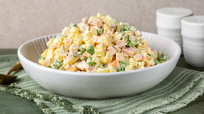 Olivier salad in a white bowl