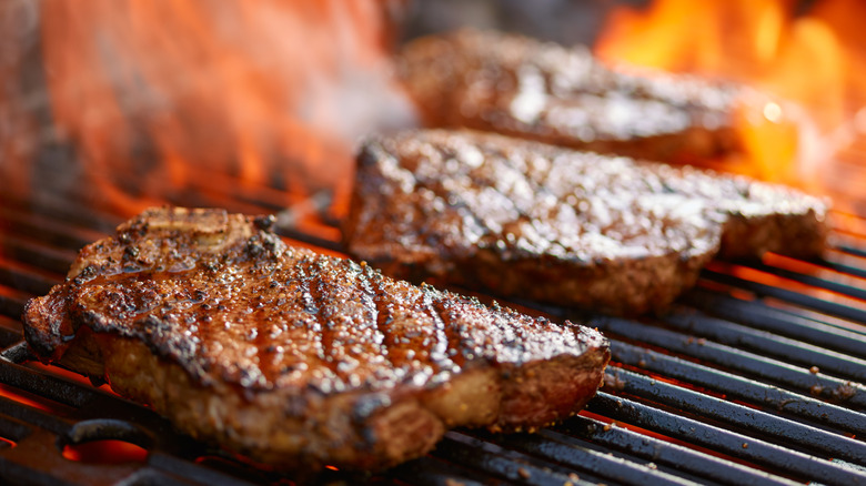 Steaks cooking on a hot grill